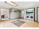 Laundry room offers hardwood floors, stacked washer and dryer units, plus storage shelves at 30651 Hollings Way, Golden, CO 80403