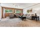 Living room with two chairs, a sofa, and large windows at 30651 Hollings Way, Golden, CO 80403