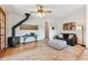 Bright living room with wood-burning stove, ceiling fan, and comfortable seating at 30651 Hollings Way, Golden, CO 80403