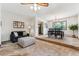 Cozy living room with comfortable seating area and adjacent dining space with large windows at 30651 Hollings Way, Golden, CO 80403