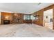 Spacious living room features a stone fireplace, dining area, and wood paneling details at 30651 Hollings Way, Golden, CO 80403
