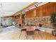 Sun room with stone accents, wood accents and adjacent sitting area and staircase at 30651 Hollings Way, Golden, CO 80403