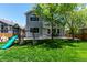 Backyard with playset and seating area, perfect for outdoor activities and entertaining at 10765 Fremont Dr, Parker, CO 80134