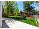 Well-maintained backyard with lush lawn, playset, and privacy fence at 10765 Fremont Dr, Parker, CO 80134