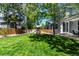 A large backyard with a play structure and lush green grass, surrounded by a wood fence at 10765 Fremont Dr, Parker, CO 80134