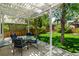 Cozy backyard patio with a pergola, glass table, and seating for outdoor entertaining at 10765 Fremont Dr, Parker, CO 80134