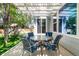 Shaded backyard patio with table and chairs, perfect for relaxing outdoors next to a play structure at 10765 Fremont Dr, Parker, CO 80134
