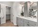 Bathroom with double vanity, framed mirrors, mosaic backsplash, and closet access at 10765 Fremont Dr, Parker, CO 80134