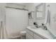 Bright bathroom featuring shower over tub, white vanity, mirror and decor at 10765 Fremont Dr, Parker, CO 80134