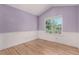 Bright bedroom with hardwood floors, chair railing, and a large window view at 10765 Fremont Dr, Parker, CO 80134