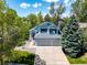 Aerial view of charming home with well-manicured lawn, three car garage, and mature landscaping at 10765 Fremont Dr, Parker, CO 80134