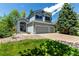Two-story home with a well-manicured lawn, mature landscaping, three car garage and a welcoming entrance at 10765 Fremont Dr, Parker, CO 80134