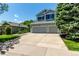 Well-manicured front lawn showcasing a home with a three-car garage on a sunny day at 10765 Fremont Dr, Parker, CO 80134