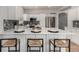 Well-lit kitchen featuring white cabinetry, granite countertops, and a central island with seating at 10765 Fremont Dr, Parker, CO 80134