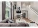 Comfortable living room area with hardwood floors, a fireplace, and a view of the staircase at 10765 Fremont Dr, Parker, CO 80134