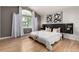 A bright and airy main bedroom with a large window, accent wall, and modern decor at 10765 Fremont Dr, Parker, CO 80134