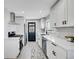 Modern kitchen with white cabinets and quartz countertops at 1322 W Alaska Pl, Denver, CO 80223