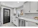 Modern kitchen with white cabinets and black accents at 1322 W Alaska Pl, Denver, CO 80223