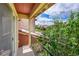 Balcony view showcasing lush greenery and neighborhood homes against a bright, partly cloudy sky at 9538 Pendio Ct, Highlands Ranch, CO 80126