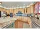 Well-equipped kitchen featuring stainless steel appliances, marble countertops, and ample cabinet space at 9538 Pendio Ct, Highlands Ranch, CO 80126