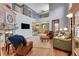 Bright and airy living room with high ceilings, wood floors, and fireplace, flowing into the kitchen at 9538 Pendio Ct, Highlands Ranch, CO 80126