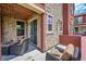 Inviting covered patio with stone accents, outdoor seating, and sliding door access to the interior at 9538 Pendio Ct, Highlands Ranch, CO 80126