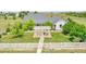 Aerial view of the property featuring a white picket fence, pergola, and landscaping at 56920 E 42Nd Ct, Strasburg, CO 80136