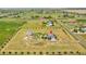Aerial view showcases a large property with a home, barn, and surrounding landscape at 56920 E 42Nd Ct, Strasburg, CO 80136