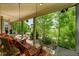 Inviting back porch with swing and comfortable seating overlooking lush landscaping at 56920 E 42Nd Ct, Strasburg, CO 80136