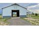 Barn featuring large door, a spacious interior, and ample outdoor space at 56920 E 42Nd Ct, Strasburg, CO 80136