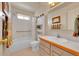 Bathroom with a tub/shower combination, a single sink vanity, and a mirror at 56920 E 42Nd Ct, Strasburg, CO 80136