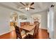 Traditional dining room featuring a wood table, matching chairs, and ceiling fan at 56920 E 42Nd Ct, Strasburg, CO 80136