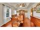 Formal dining room with tray ceiling, wood table and chairs, and display cabinet at 56920 E 42Nd Ct, Strasburg, CO 80136