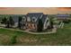Charming two-story home with covered front porch and brick walkway leading to manicured lawn at 56920 E 42Nd Ct, Strasburg, CO 80136