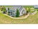 Charming two-story home with covered front porch and brick walkway leading to manicured lawn at 56920 E 42Nd Ct, Strasburg, CO 80136