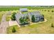 Expansive property featuring a two-story home, barn, outbuilding, and mature trees at 56920 E 42Nd Ct, Strasburg, CO 80136