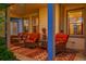Inviting front porch with comfortable wicker seating and a porch swing at 56920 E 42Nd Ct, Strasburg, CO 80136