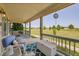 Inviting front porch with comfortable seating and scenic views of the surrounding landscape at 56920 E 42Nd Ct, Strasburg, CO 80136