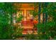 Cozy front porch with a wooden swing framed by lush greenery at 56920 E 42Nd Ct, Strasburg, CO 80136