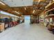 Open and spacious garage with ample room for multiple vehicles or equipment and an abundance of tools and storage at 56920 E 42Nd Ct, Strasburg, CO 80136