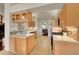 Modern kitchen with stainless steel appliances, quartz countertops, and light wood flooring at 56920 E 42Nd Ct, Strasburg, CO 80136