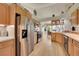 Updated kitchen featuring stainless steel appliances, light wood cabinets, and open layout to dining area at 56920 E 42Nd Ct, Strasburg, CO 80136