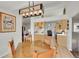 Eat-in kitchen boasts modern lighting, stainless steel appliances, and wood cabinets at 56920 E 42Nd Ct, Strasburg, CO 80136