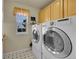 Convenient laundry room equipped with modern washer and dryer units at 56920 E 42Nd Ct, Strasburg, CO 80136