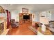 Cozy living room featuring a fireplace, hardwood floors, and comfortable seating at 56920 E 42Nd Ct, Strasburg, CO 80136
