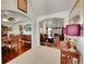 Inviting open-concept living space with hardwood floors, fireplace, and archway to dining area at 56920 E 42Nd Ct, Strasburg, CO 80136