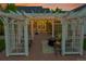 Pergola with outdoor seating, fire pit, and string lights for evening ambiance at 56920 E 42Nd Ct, Strasburg, CO 80136