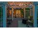 Pergola with outdoor seating, fire pit, and string lights on a brick patio with patio umbrella at 56920 E 42Nd Ct, Strasburg, CO 80136