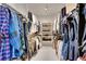 Spacious walk-in closet featuring ample hanging space and shelving for organized storage at 56920 E 42Nd Ct, Strasburg, CO 80136