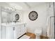 Bright bathroom with double vanity, large mirror, and walk-in shower at 14800 Foothill Rd, Golden, CO 80401